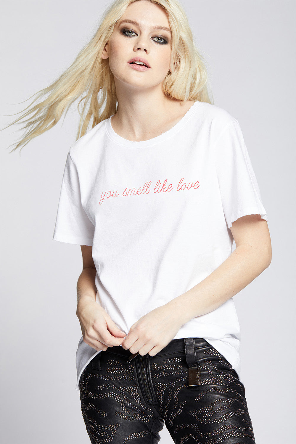 Oversized You Smell Like Love T-shirt in White with red cursive text