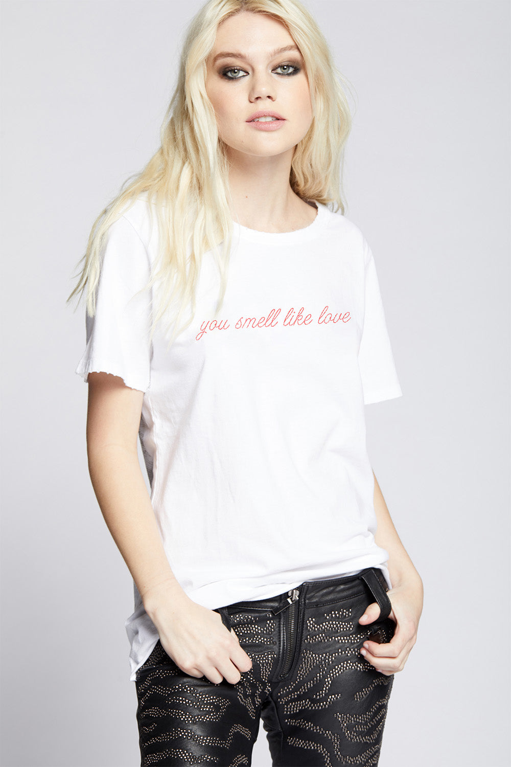 Oversized You Smell Like Love T-shirt in White with red cursive text