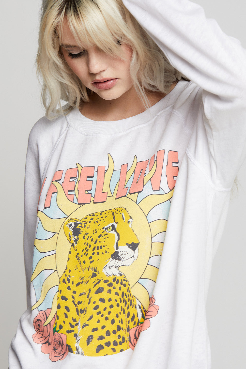 Oversized I Feel Love Sweatshirt in White with cheetah, sun, rose, and text graphics