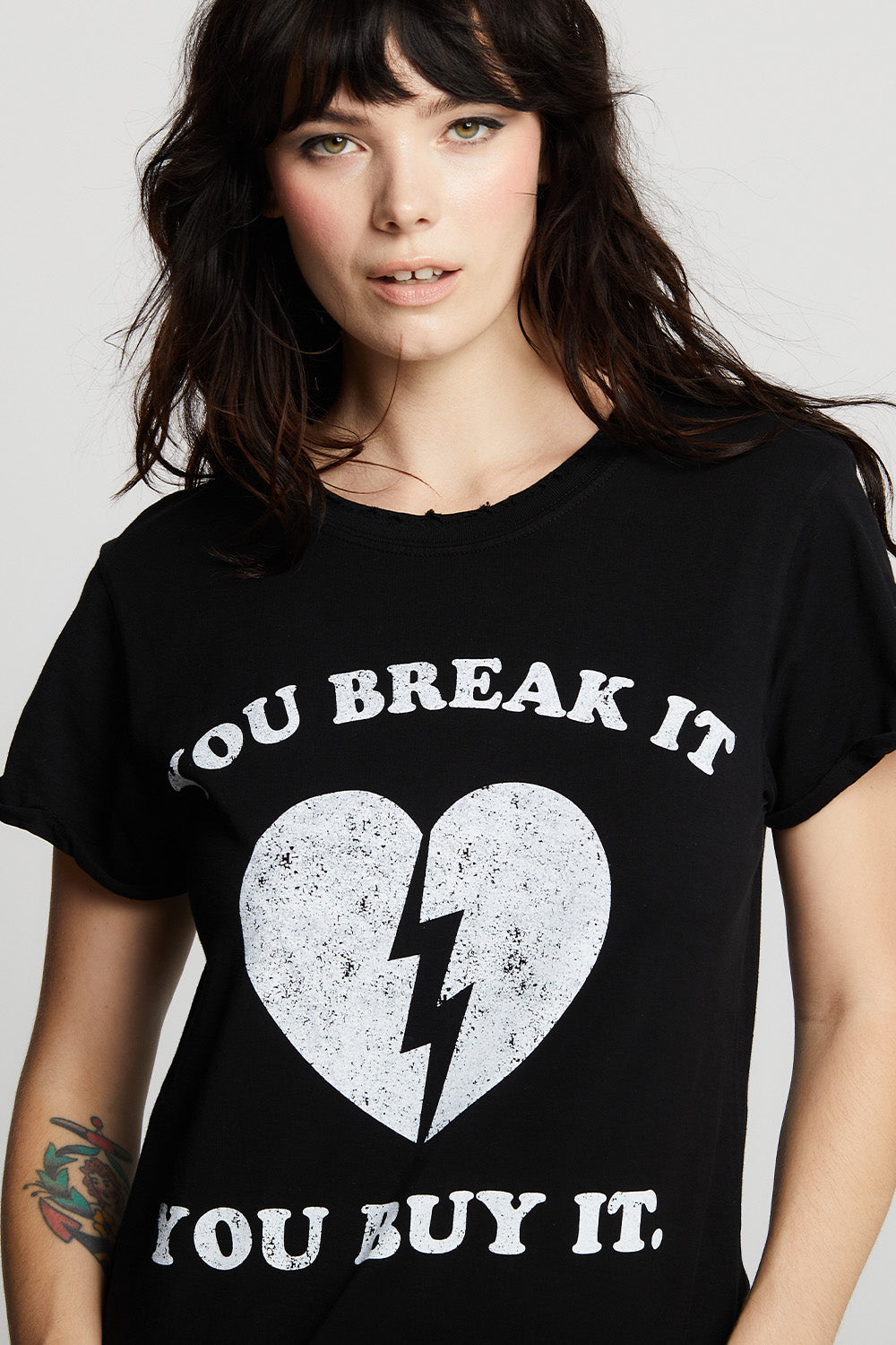 Women's "You Break It, You Buy It" Heart T-shirt in Black with broken heart graphic.