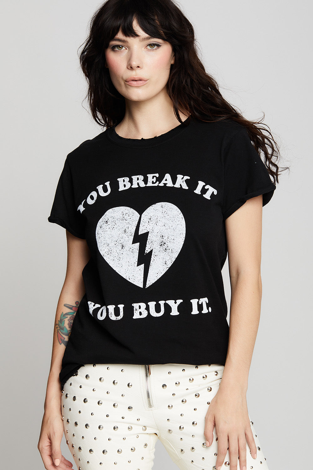 Women's "You Break It, You Buy It" Heart T-shirt in Black with broken heart graphic.