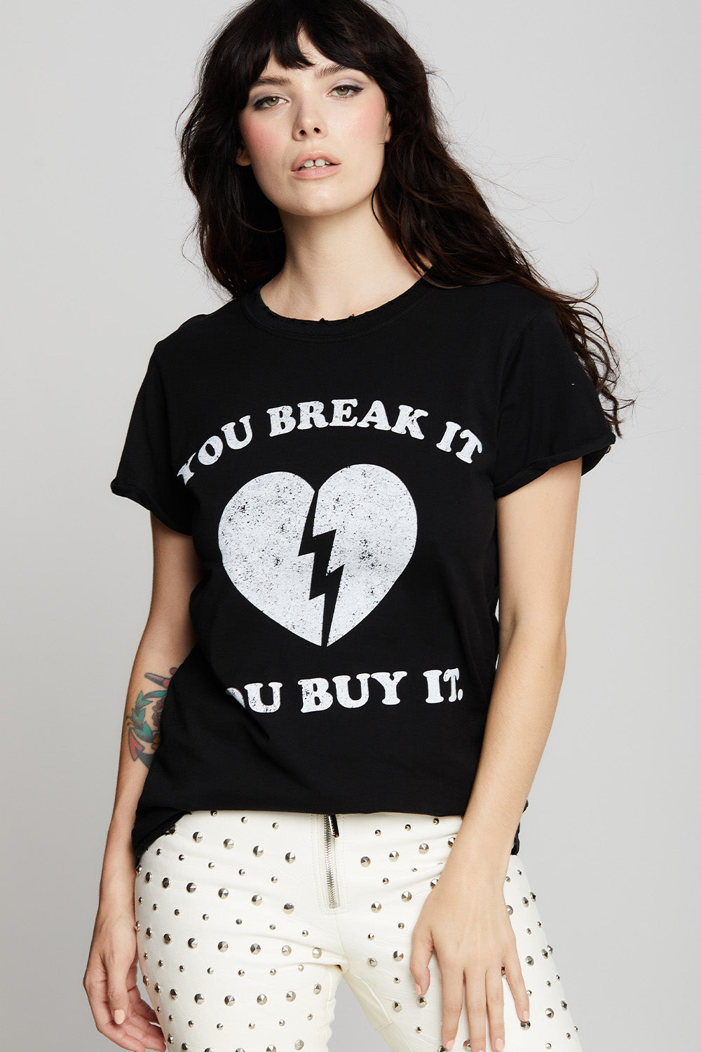 Women's "You Break It, You Buy It" Heart T-shirt in Black with broken heart graphic.