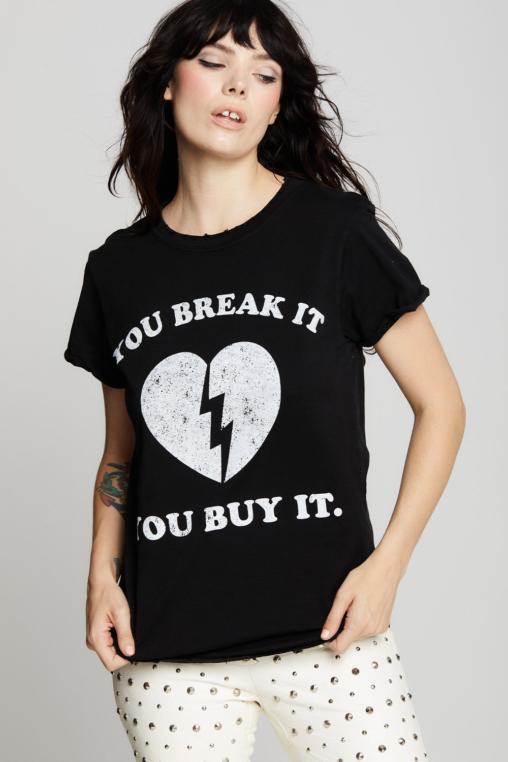 Women's "You Break It, You Buy It" Heart T-shirt in Black with broken heart graphic.