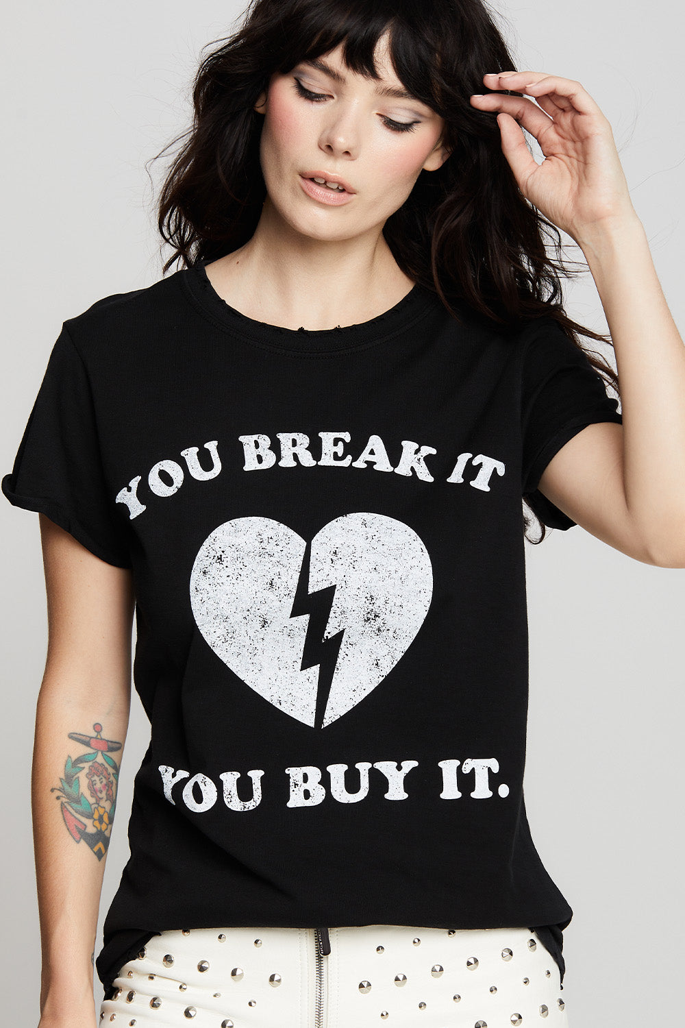 Women's "You Break It, You Buy It" Heart T-shirt in Black with broken heart graphic.
