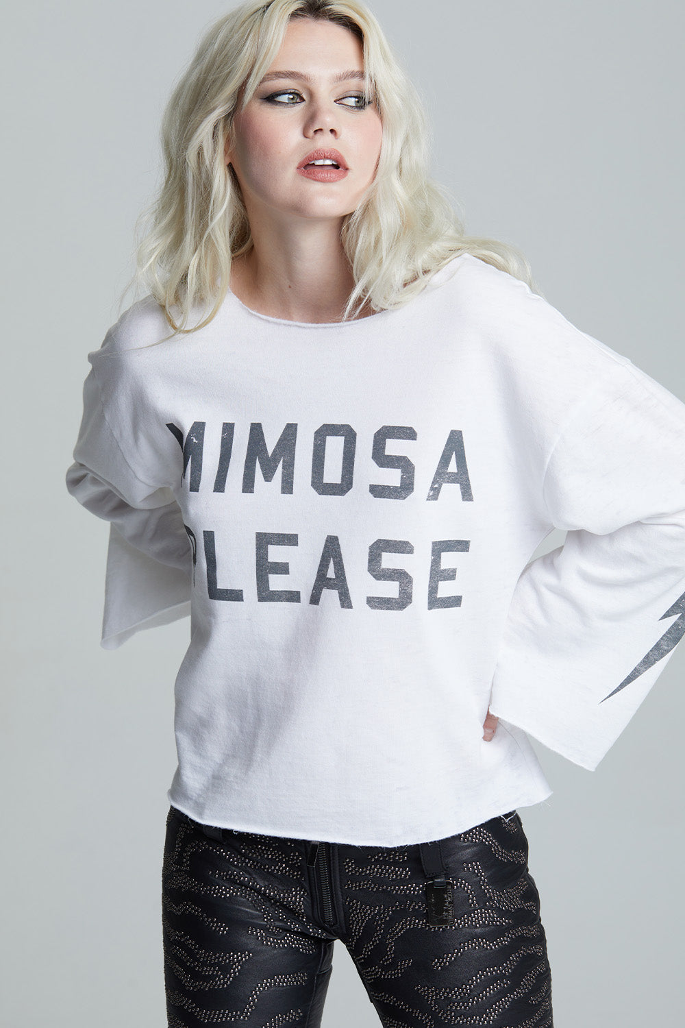 Women's white 'Mimosa Please' bell sleeve top with distressed graphics and a bolt on the sleeve.