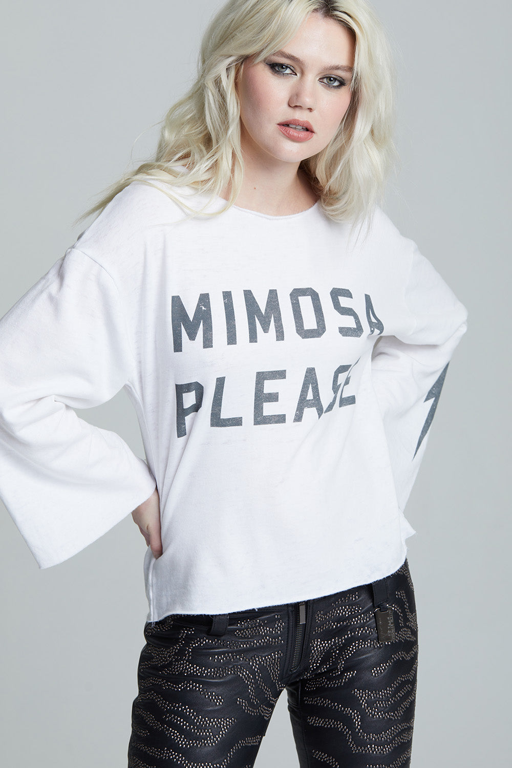 Women's white 'Mimosa Please' bell sleeve top with distressed graphics and a bolt on the sleeve.